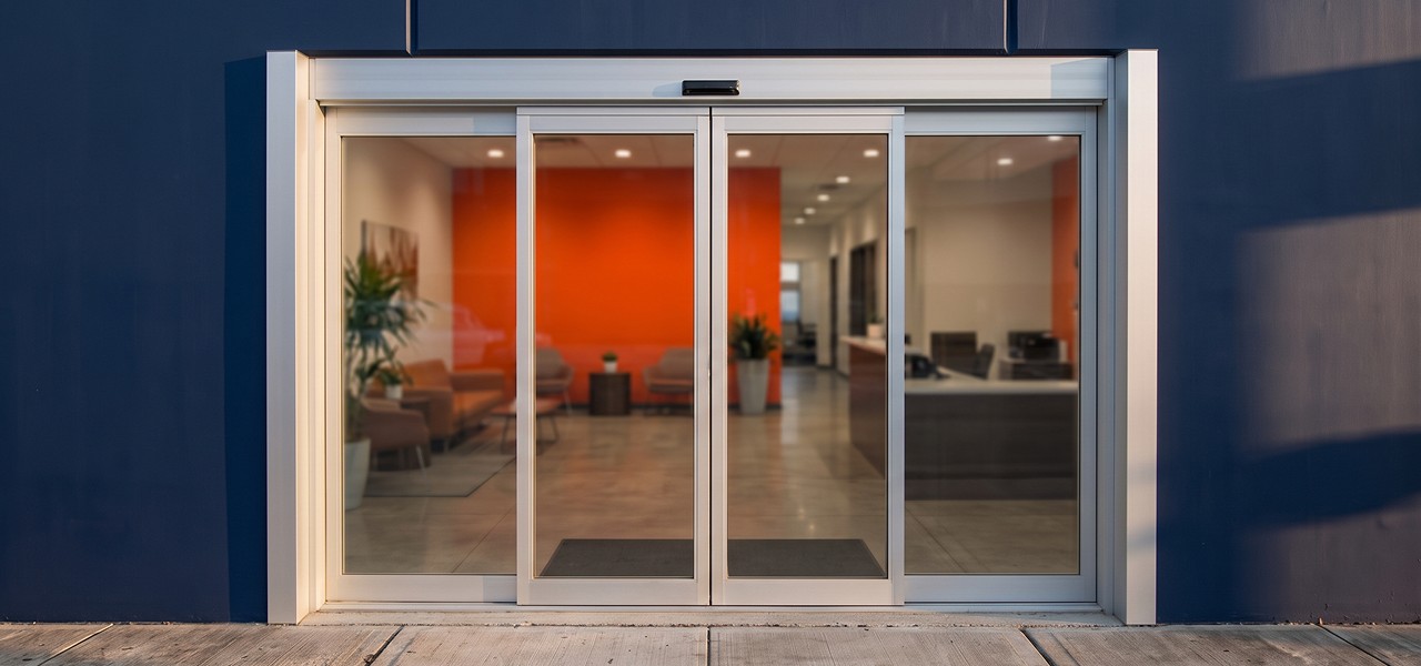 Automatic commercial sliding glass doors for a modern office entrance